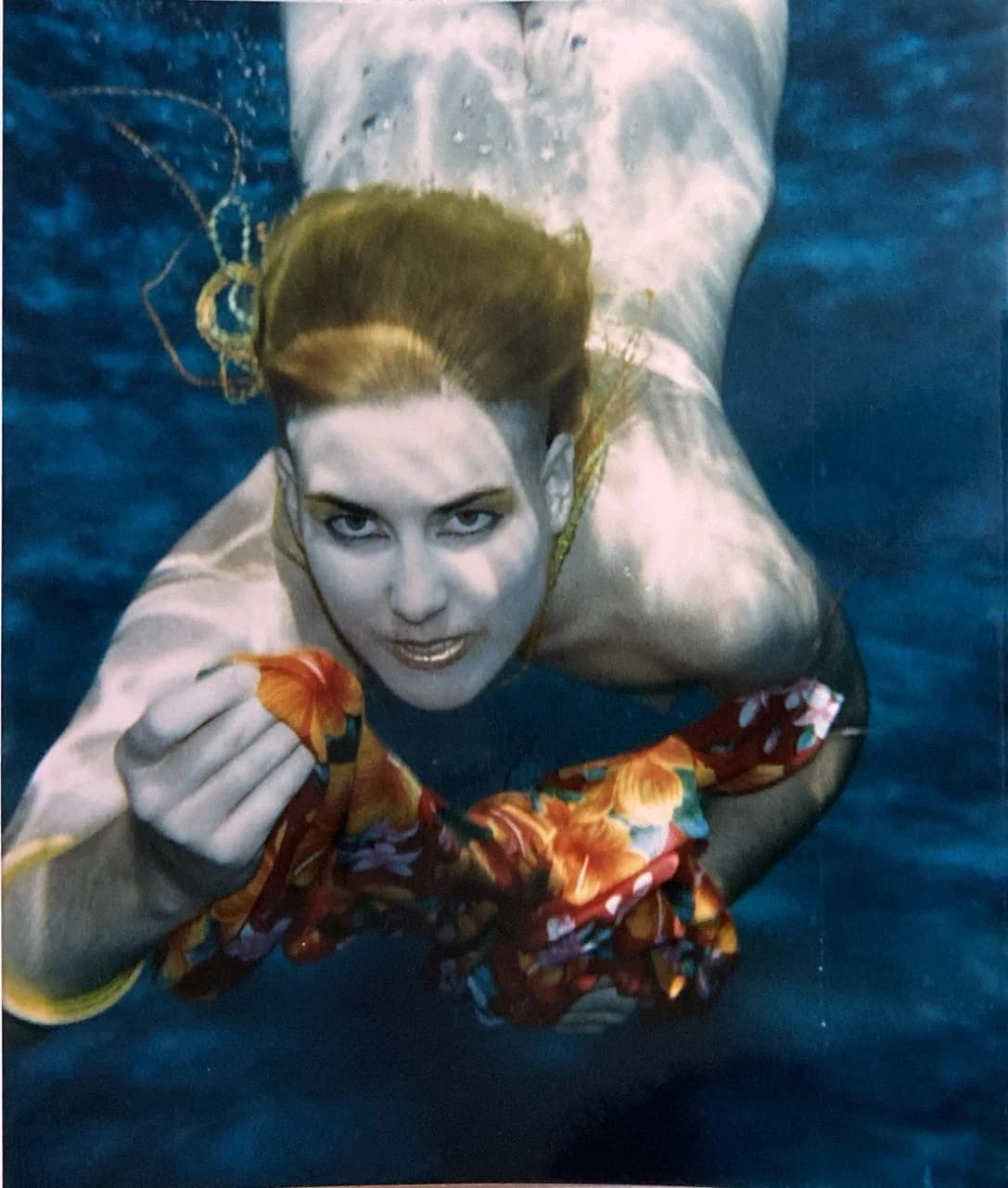Underwater fashion photography. Floral dress, submerged.
