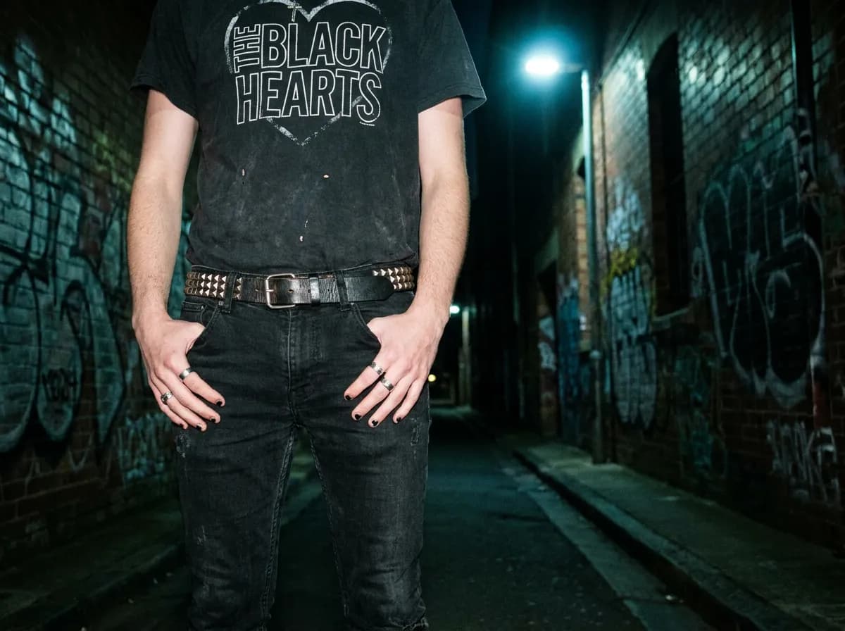 Studded belt and faded band tee, emo street style