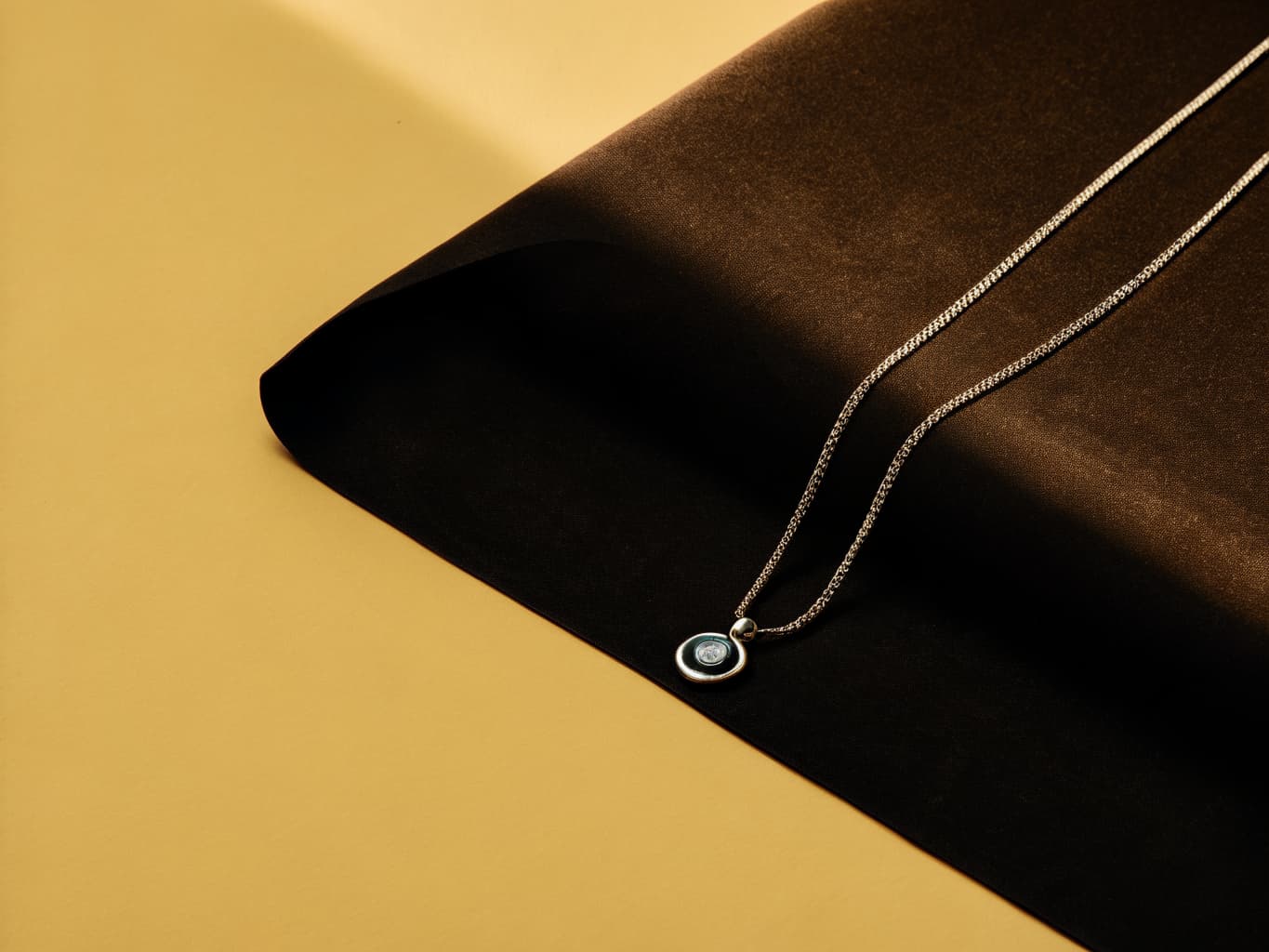 Delicate discreet day collar necklace with a small pendant, styled as elegant everyday jewelry